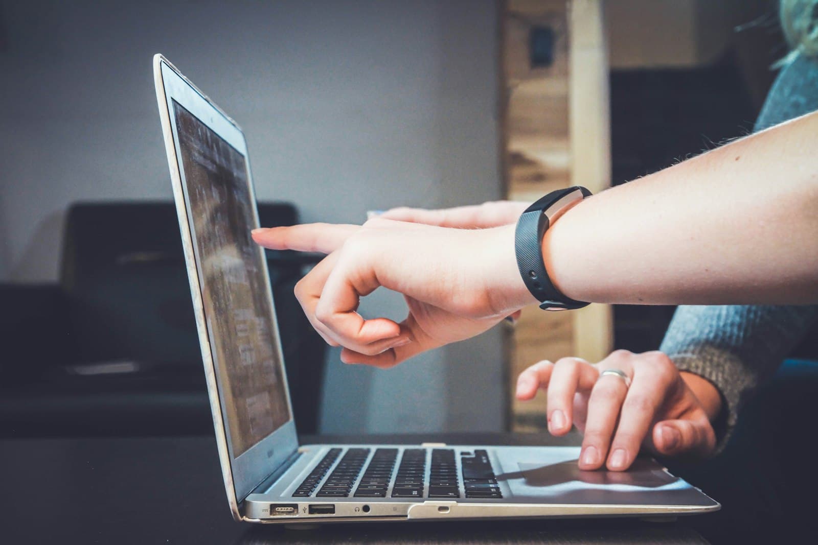 Mentor guiding a learner on a laptop